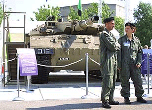 Israeli soldiers guard an Israeli Merkava tank at the Eurosatory military equipment show held in Villepinte, north of Paris, June 17. Israel showed the world’s military shoppers fruits of its hich-tech arm industry.
