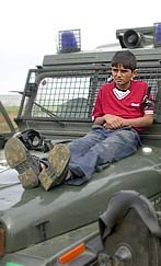 Palestinian child used as a human shield by Israeli soldiers.